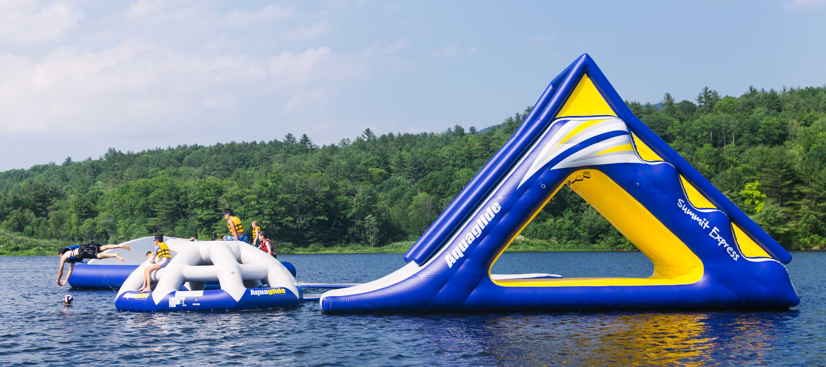 Boys on waterpark jumping into lake