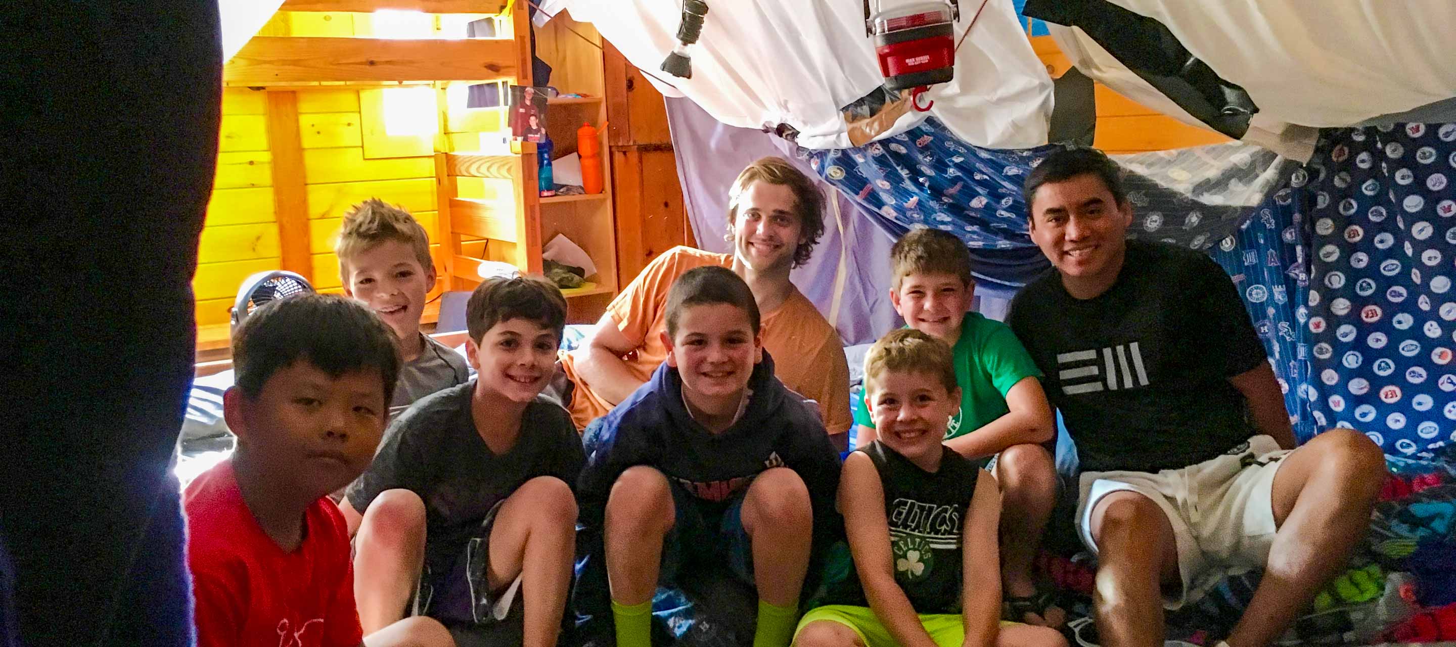 Boys in bunk under a fort