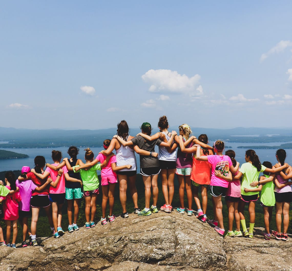 Girls on mountain top looking at view