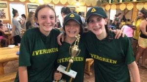 Three girls smiling with trophy