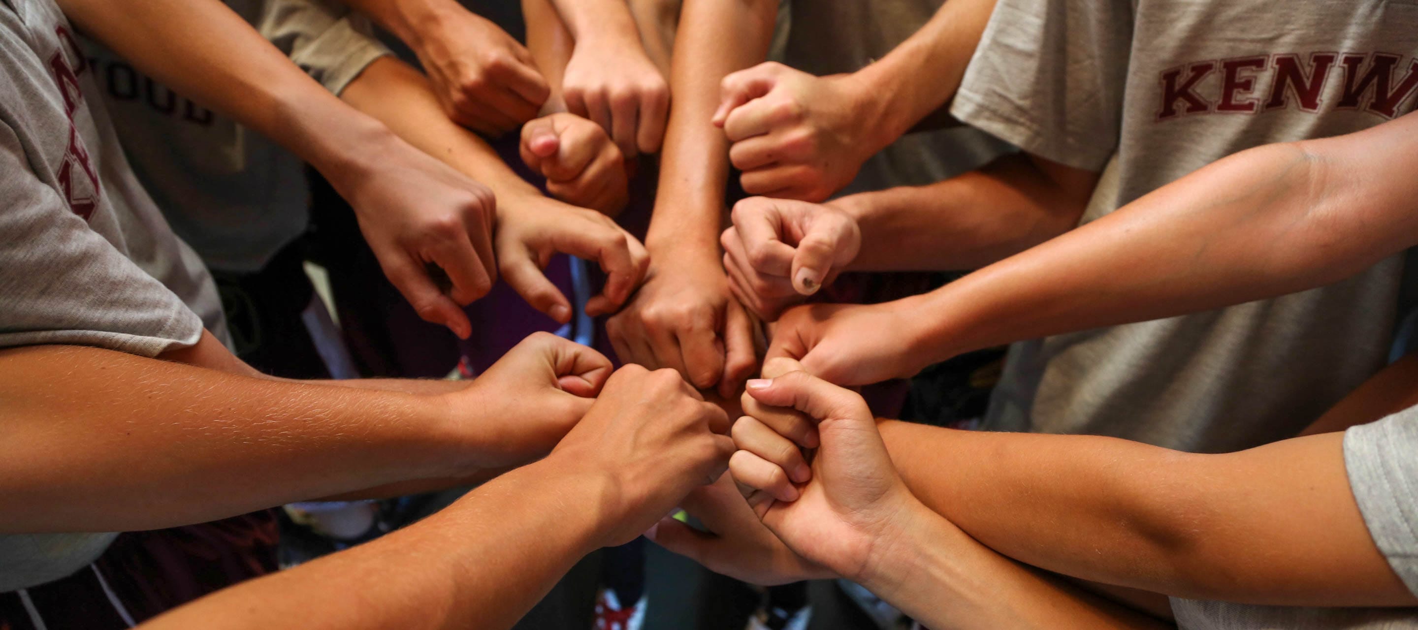 Boys doing a team huddle